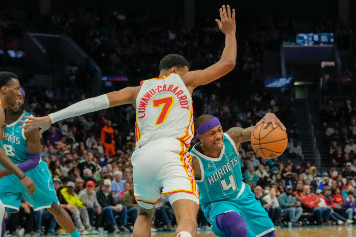 Mar 16, 2022; Charlotte, North Carolina, USA; Charlotte Hornets guard Isaiah Thomas (4) tries to corner around Atlanta Hawks guard Timothe Luwawu-Cabarrot (7) during the second half at the Spectrum Center.